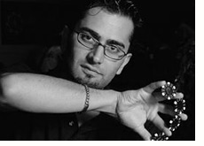 poker player Antonio Esfandiari is holding chips in his right hand - l.a. poker classic