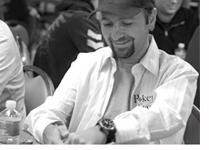 poker player daniel negreanu is hiding his cards while playing poker